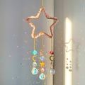 Pink natural crushed stone pentagram suncatcher with crystal prisms reflecting rainbow light - Rose Quartz