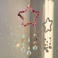 Star-shaped amethyst crystal suncatcher with golden moon pendants and rainbow reflections - Amethyst