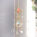 Golden suncatcher with orange gemstone and crystal prisms casting rainbow light - Watermelon red / 55cm