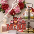 Hanging wooden Be Mine Valentine's Day heart ornament with red and white festive patterns - BE MINE Text