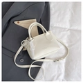 Detailed macro view of cream leather handbag featuring pearl bow charms and lace trim - White (With Charm)