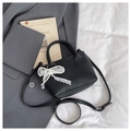 Detail of black lychee grain texture on bucket bag with pearl lace bow charm - Black (With Charm)