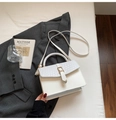 Elegant white crossbody handbag with woven flap detail and gold metal clasp in a stylish setup - White