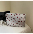 Silver cherry print laptop sleeve with dual zippers on a desk with a laptop and book - Silver