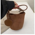 Chic brown suede bucket bag with matching round charm accessory and slim top handle - Coffee
