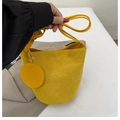 Yellow suede bucket shoulder bag featuring a matching round coin purse pendant - Yellow