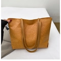 Detailed macro view of yellow tote bag featuring a textured leather finish and soft straps - Basic Style / Brown