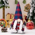 Christmas gnome plush in blue and red plaid hat holding wooden skis and poles - Female Style (White Braids)