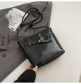 Glossy black bucket bag with gold hardware and stylish knot strap on a grey blazer - Black PU Leather