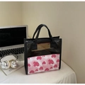 Pink heart printed tote bag with transparent PVC top and black handles on white desk - Pink