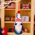 Patriotic knit gnome ornament with stars and stripes hanging on a white branch - Pointed Hat Male Style