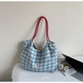 Close-up of blue and white checkered tote bag with contrasting thick red rope handles - Blue