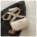 Close-up of beige square handbag with golden bow decoration and wide shoulder strap - Off White