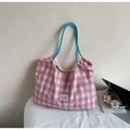 Detail showing pink and white gingham tote bag with blue checkered rope handles and tag - Pink