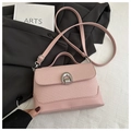 Detail of pink patchwork crossbody bag with metallic horseshoe clasp and woven texture - Pink