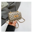 Close-up of vintage brown pattern crossbody bag with gold lock and chain strap detail - Dark Khaki