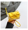 Detail of yellow mini crossbody bag with a large bow and white lace trim decoration - Yellow