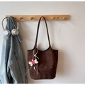 Bolso tote de gamuza marrón oscuro con amuleto de perro, colgado en un perchero de madera - Con Colgante / Marrón