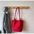 Chic red suede tote bag with long handles hanging on wall with lifestyle accessories - No Pendant / Red