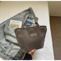 Detail of gray waterproof nylon handbag with Fashion label and woven handle straps - Gray