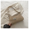 Detalle de bolso beige en cuero con hebilla plateada y textura suave de alta calidad - Caqui