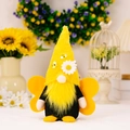 Gnome plush in bee theme with yellow pointed hat and wings standing in garden decor - Male Style