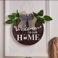 Rustic round wooden Welcome To Our Home sign with snowman icon and greenery decoration - Interchangeable Accessories Double-Sided Door Hanger