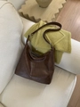 Vintage brown large capacity tote bag in soft leather finish on a cozy sofa - Coffee