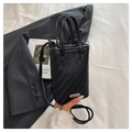 Minimalist black woven crossbody bag with silver buckle and matte leather texture finish - Black