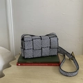 Pink woven crossbody bag with black and white geometric logo patterns and golden hardware - Gray