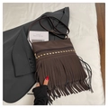 Detail of brown leather crossbody bag with golden studs and long bohemian tassels - Brown
