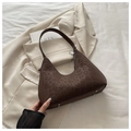 Close-up of leopard print hobo bag with silver zipper and bottom studs on white fabric - Brown Leopard