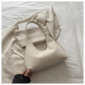 Detail of cream crescent leather bag with JIASHITU logo and metal feet on base - White