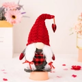 Handmade Valentine gnome with red knit hat and heart charm on a soft pink background - Female Style (Braids And Heart Decor)