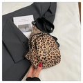 Detail of leopard print chest bag with zippers on a grey blazer for a stylish look - Leopard Print