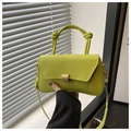 Detail of neon green crossbody bag with knotted handle and golden metal buckle - Green