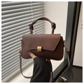 Detail of dark brown leather handbag with gold square buckle and thick knotted handle design - Brown