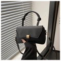 Detail view of black matte leather square bag with gold buckle and knotted top handle - Black
