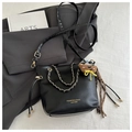 Black leather bucket bag with gold chain strap and brown bear plush charm accessory - L / Black With Pendant