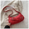 Chic red crescent underarm bag with decorative silver buckle straps and long shoulder strap - Red