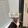 Chic silver mini crossbody flap bag with decorative belt buckles and thin strap - Silver