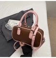 Detail view of pink and chocolate brown boston bag with silver hardware on soft bedding - Brown & Pink (No Pendant)
