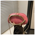 Detail of pink lacquer crossbody bag featuring a large U-shaped golden metal handle - Hot Pink