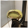 Detailed close-up of light green patent leather shell bag with gold U-shaped handle - Avocado Green