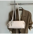 Detail of light pink shoulder bag featuring a lace pearl bow and silver heart pendant - White with Pendant