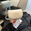 Minimalist crinkled leather crossbody bag in cream white with round button closure - White