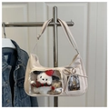 Detail of off-white PU tote bag featuring transparent window with plush dog charm - White