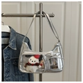 Detail view of silver PU shoulder bag featuring a clear window with dog plush and bow decor - Silver