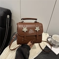 Brown leather crossbody bag with star details and white fashion typography print - Brown
