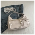 Creamy white PU ita bag with double transparent windows and bow detail shown on denim - Off White